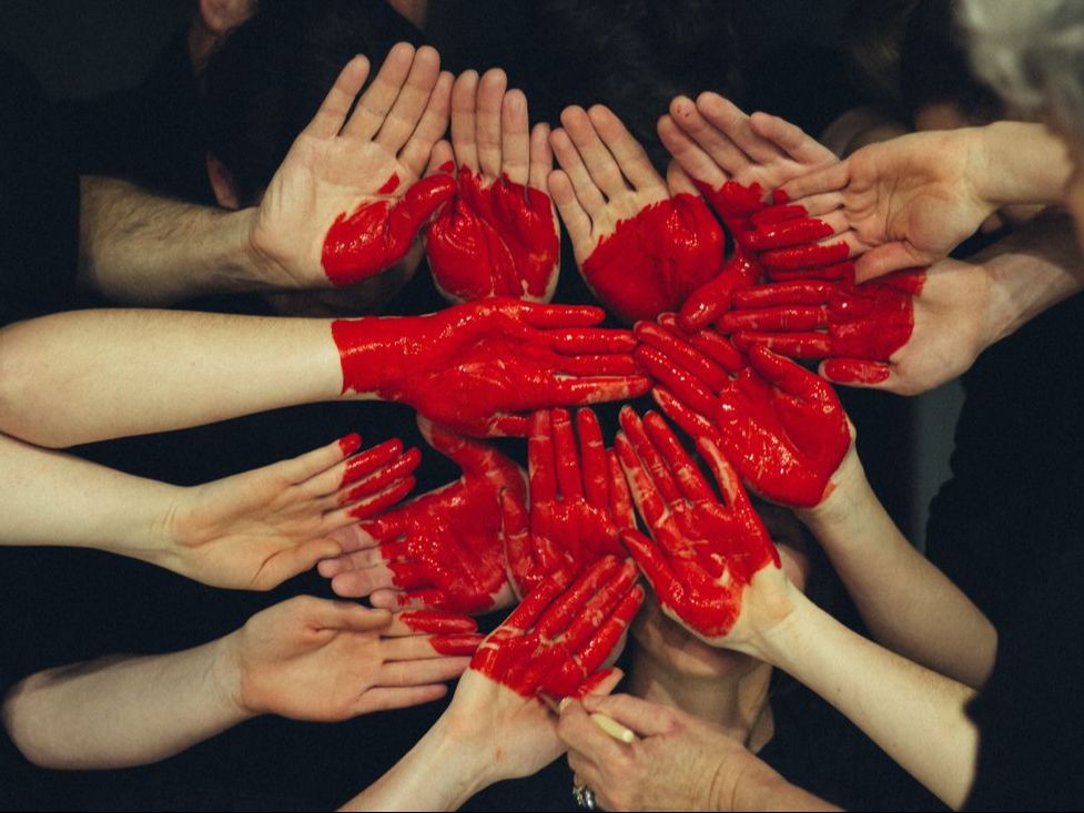 Picture of many hands painted with red heart