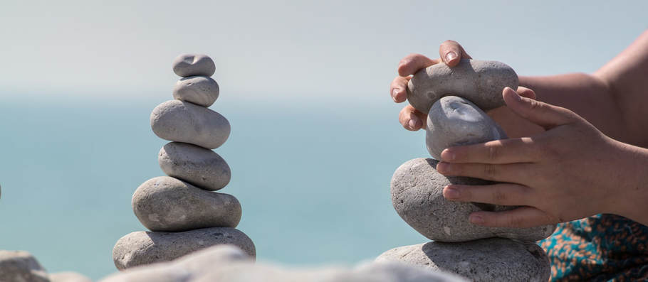 Picture of hands balancing rocks